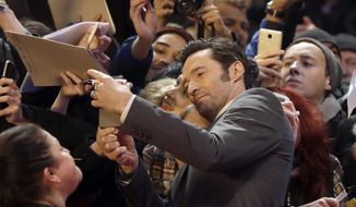 Actor Hugh Jackman poses with fans on the red carpet for the film &#39;Logan&#39; at the 2017 Berlinale Film Festival in Berlin, Germany, Friday, Feb. 17, 2017. (AP Photo/Michael Sohn)