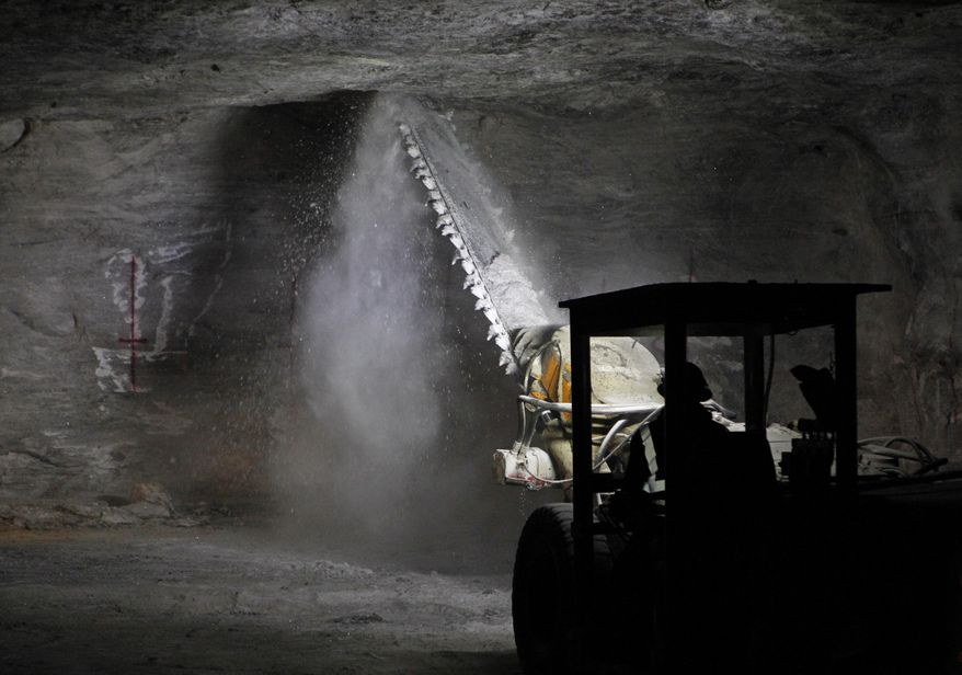 In this Jan. 27, 2017 photo, an American Rock Salt Co. worker operates an undercutter to trim a piece of low-hanging roof at the mine in Hampton Corners, N.Y. Inside the nation’s most productive road salt mine, workers in ghostly tunnels are praying for snow. Fiercer winters mean better business, longer hours and fatter paychecks at what’s billed as the nation’s most productive salt mine, which ships trainloads of snow-melting road salt to municipalities across the Northeast. (AP Photo/Jeffrey T. Barnes)