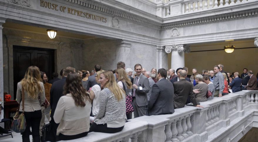 In this Thursday, Feb. 16, 2017, photo, lobbyists gather outside the Utah House of Representatives at the Utah State Capitol in Salt Lake City. Lobbyists who represent health care companies took a group of lawmakers who oversee health issues to dinner this week at an upscale restaurant in Salt Lake City. Lawmakers who attended all sit on committees that oversee health issues, but they say they were not lobbied health issues and it was a routine social event. (AP Photo/Rick Bowmer)