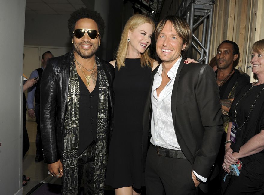 FILE - In this June 5, 2013, file photo, musician Lenny Kravitz, left, actress Nicole Kidman and country singer Keith Urban pose at the 2013 CMT Music Awards at Bridgestone Arena in Nashville, Tenn. Kidman has revealed that she was once engaged to Kravitz. Kidman confirmed the engagement with the rocker in a recent interview with Net-A-Porter's magazine "The Edit," in which she was discussing her upcoming HBO series "Big Little Lies." (Photo by Frank Micelotta/Invision/AP, File)