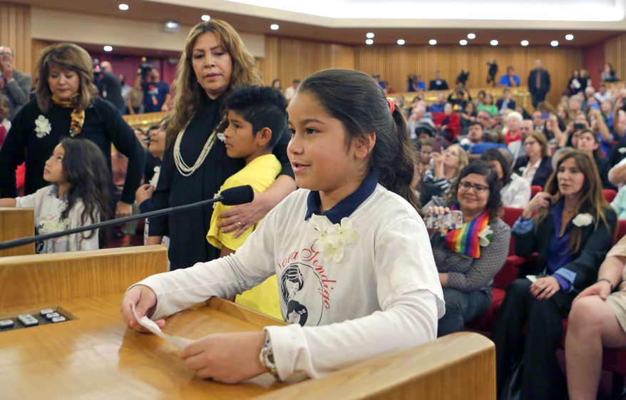 Shirley Vanegas, daughter of illegal immigrants, addresses Miami-Dade County commissioners in the county building, Friday, Feb. 17, 2017, in downtown Miami. Vanegas asked the commissioners to reverse Mayor Carlos Gimenez's position on immigration that requires local police to work with federal officers to enforce immigration law. (AP Photo/Alan Diaz)