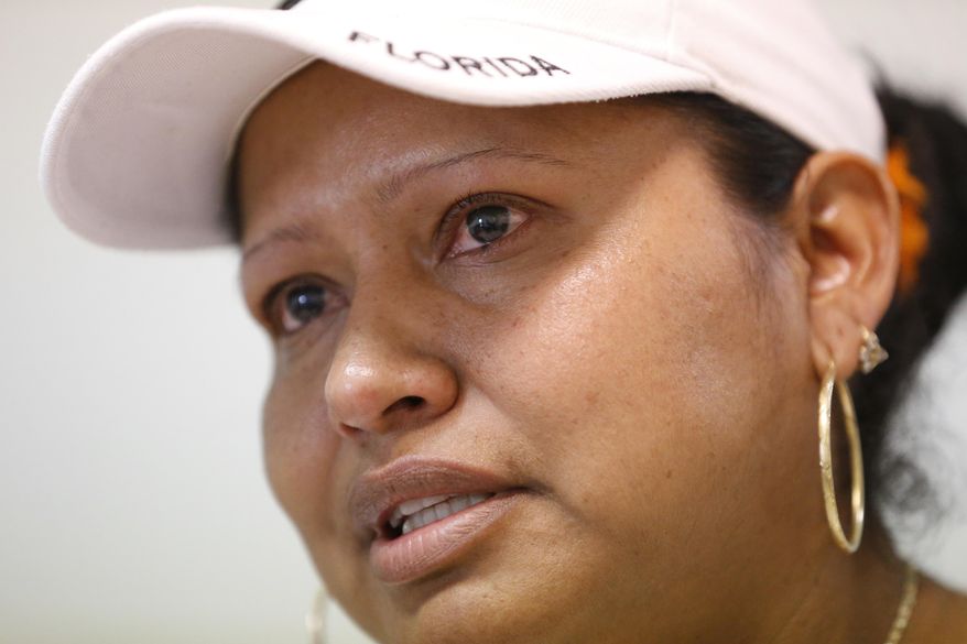In this, Monday, Feb. 13, 2017, photo, tears well up in the eyes of Marina, 34, of Mexico, as she speaks during an interview with The Associated Press in Homestead, Fla. A county with an immigrant leader where most people were born abroad has bucked the trend of the sanctuary city movement, creating fear among the undocumented and exposing a long-standing disconnect between Cuban-Americans and the rest of the Latinos. Miami-Dade's Cuban-born Mayor Carlos Gimenez went against other immigrant-rich cities in ordering its officials to abide by President Donald Trump's immigration orders. (AP Photo/Wilfredo Lee)