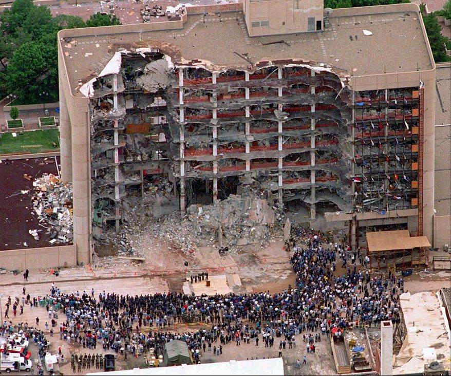 FILE - In this May 5, 1995 file photo, a large group of search and rescue crew attends a memorial service in front of the Alfred P. Murrah Federal Building in Oklahoma City. In 1995, domestic terrorism seemed to be the most immediate threat to Americans. Now President Donald Trump and his supporters say the nation’s greatest security risk lies in attackers who potentially sneak into the U.S. from abroad. But a list of worldwide attacks recently released by the administration left off many that were carried out by right-wing extremists and white supremacists. (AP Photo/Bill Waugh, File)