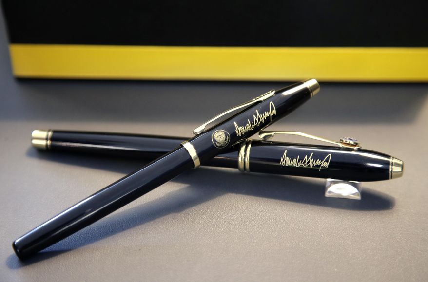 In this Tuesday, Feb. 14, 2017, photo A.T. Cross Co. custom-made pens designed for President Donald Trump, featuring his signature and presidential seal, are displayed at the Cross Company Store in Providence, R.I. The President chose the Cross Century II model pen, top, for deliveries to the White House over the Cross Townsend model pen, below. (AP Photo/Steven Senne)