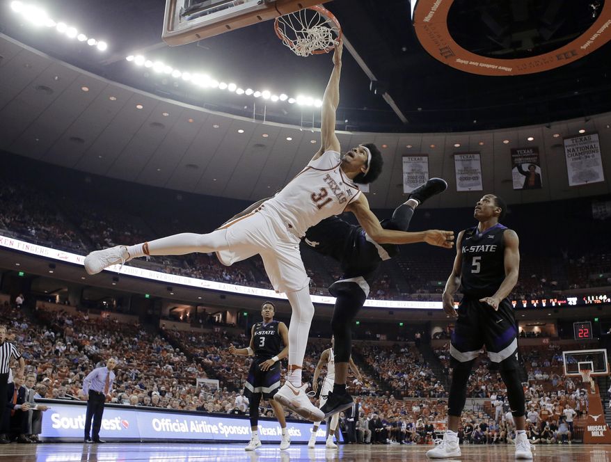 Texas forward Jarrett Allen (31) is fouled by Kansas State forward D.J. Johnson (4) as he tires to score during the second half of an NCAA college basketball game, Saturday, Feb. 18, 2017, in Austin, Texas. Kansas State won 64-61. (AP Photo/Eric Gay)