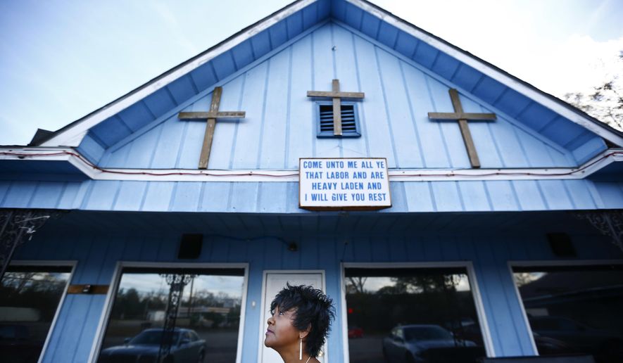 In this Jan. 18, 2017 photo, Chrycynthia Davis, mother of Kharon Davis, poses for a portrait in Dothan, Ala. Kharon Davis was 22-years-old when he was arrested on a capitol murder charge in 2007 and booked into the Houston County Jail. Davis has spent nearly a third of his life held without bond in the jail waiting for trial. (AP Photo/Brynn Anderson)