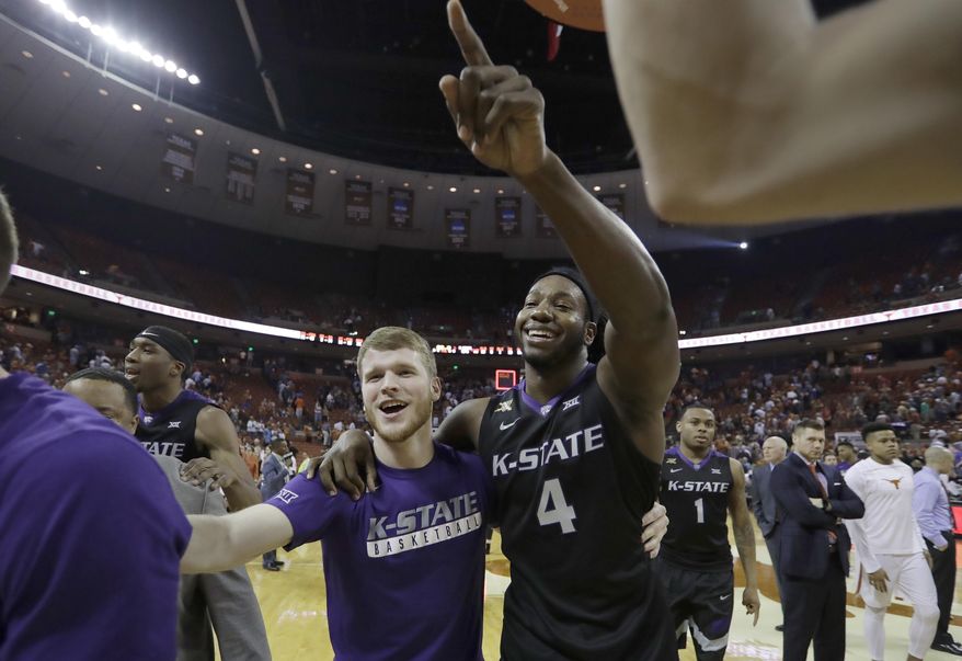 Kansas State forward D.J. Johnson (4) celebrates with teammates after he hit the winning shot in the final seconds of the second half of an NCAA college basketball game against Texas, Saturday, Feb. 18, 2017, in Austin, Texas. Kansas State won 64-61. (AP Photo/Eric Gay)