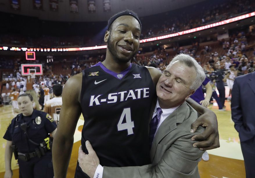 Kansas State forward D.J. Johnson (4) celebrates with head coach Bruce Weber after he hit the winning shot in the final seconds of the second half of an NCAA college basketball game against Texas, Saturday, Feb. 18, 2017, in Austin, Texas. Kansas State won 64-61. (AP Photo/Eric Gay)