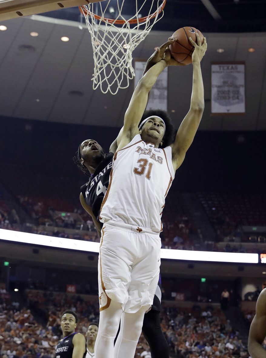 Texas forward Jarrett Allen (31) is fouled from behind by Kansas State forward D.J. Johnson (4) as he tries to score during the second half of an NCAA college basketball game, Saturday, Feb. 18, 2017, in Austin, Texas. Kansas State won 64-61. (AP Photo/Eric Gay)