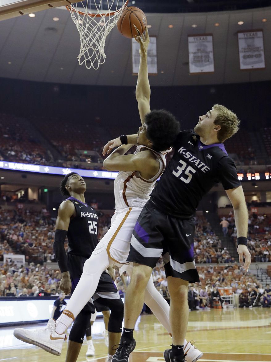Texas forward Jarrett Allen, center, is fouled by Kansas State forward Austin Budke, right, during the second half of an NCAA college basketball game, Saturday, Feb. 18, 2017, in Austin, Texas. Kansas State won 64-61. Budke was ejected after the play. (AP Photo/Eric Gay)
