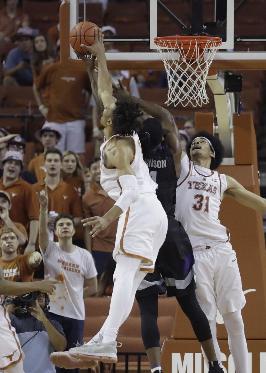 Kansas State forward D.J. Johnson, center is blocked by Texas forward Mareik Isom, left, and Texas forward Jarrett Allen (31) as he tires to score during the second half of an NCAA college basketball game, Saturday, Feb. 18, 2017, in Austin, Texas. Kansas State won 64-61. (AP Photo/Eric Gay)
