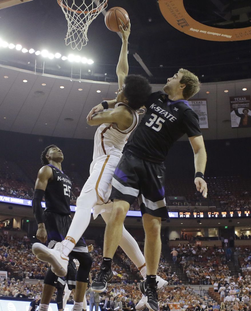 Texas forward Jarrett Allen, center, is fouled by Kansas State forward Austin Budke (35) during the second half of an NCAA college basketball game, Saturday, Feb. 18, 2017, in Austin, Texas. Kansas State won 64-61. Budke was ejected after the play. (AP Photo/Eric Gay)