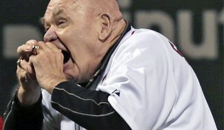 FILE - In this Sept. 21, 2012, file photo, former professional wrestler George &quot;The Animal&quot; Steele bites the baseball before throwing out the ceremonial first pitch before a baseball game between the Baltimore Orioles and Boston Red Sox at Fenway Park in Boston. WWE Hall of Fame member George &quot;The Animal&quot; Steele, whose given name was Jim Myers, has died at age 79, the WWE announced Friday, Feb. 17, 2017. (AP Photo/Charles Krupa, File)