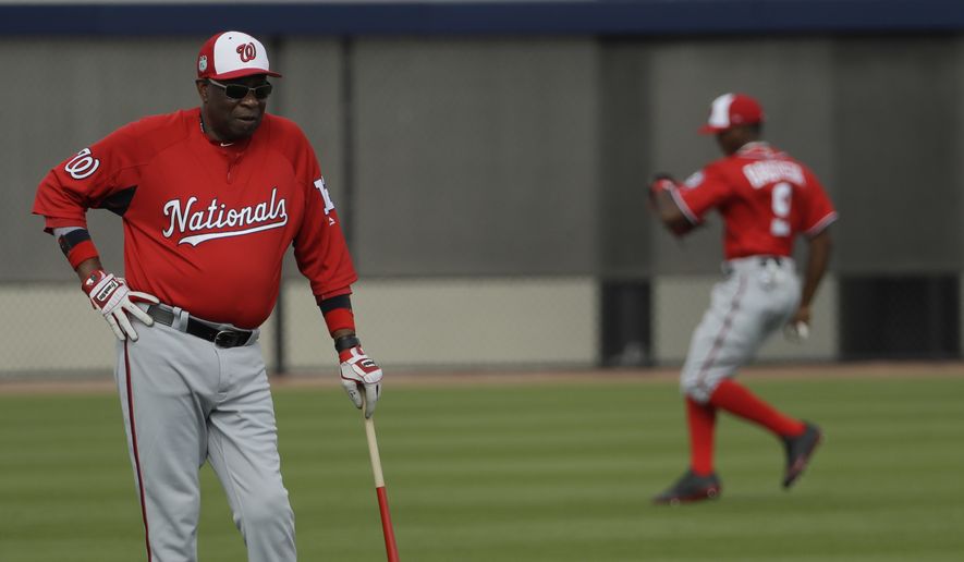 Washington Nationals manager Dusty Baker, left, watches players during a spring training baseball workout Sunday, Feb. 19, 2017, in West Palm Beach, Fla. (AP Photo/David J. Phillip)