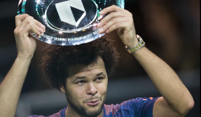 France's Jo-Wilfried Tsonga holds the trophy as he celebrates winning his match against Belgium's David Goffin in three sets, 4-6, 6-4, 6-1, in the men's singles final of the ABN AMRO world tennis tournament at the Ahoy stadium in Rotterdam, Netherlands, Sunday, Feb. 19, 2017. (AP Photo/Peter Dejong)