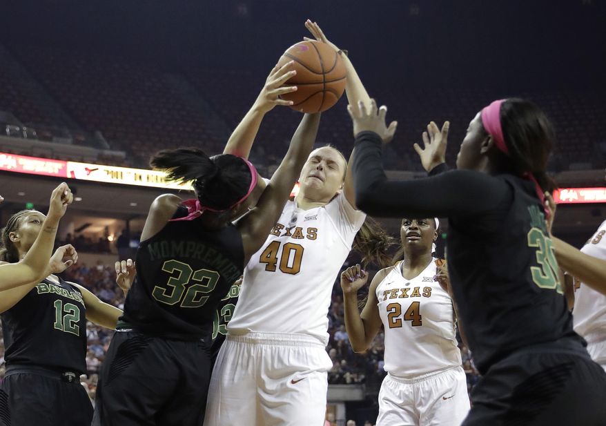 Texas center Kelsey Lang (40) and Baylor forward Beatrice Mompremier (32) scramble for a rebound during the first half of an NCAA college basketball game, Monday, Feb. 20, 2017, in Austin, Texas. (AP Photo/Eric Gay)