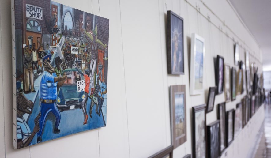 FILE - In this Jan. 5, 2017, photo, a painting by David Pulphus is shown hung in a hallway displaying paintings by high school students selected by their member of congress on Capitol Hill in Washington.  The office of Missouri Democratic Rep. William Lacy Clay has announced he intends to file a federal lawsuit Tuesday over the removal of a constituent&#39;s painting from its Capitol Hill display.   (AP Photo/Zach Gibson)