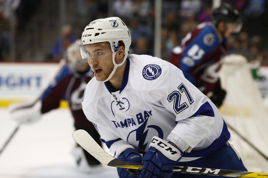 Tampa Bay Lightning left wing Jonathan Drouin turns to celebrate with teammates after scoring the winning goal past Colorado Avalanche goalie Calvin Pickard, back left, and left wing Matt Nieto in overtime of an NHL hockey game ,Sunday, Feb. 19, 2017, in Denver. Tampa Bay won 3-2. (AP Photo/David Zalubowski)