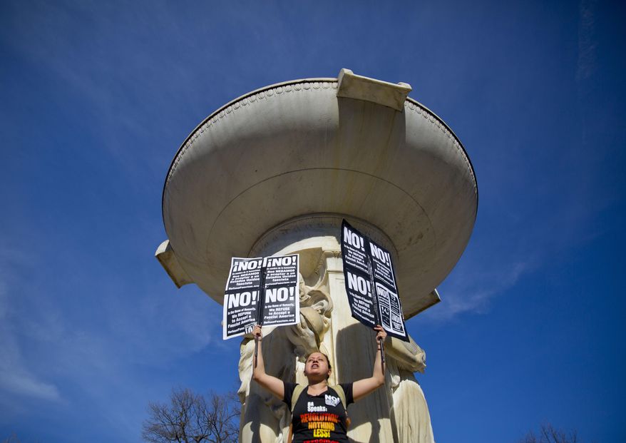 Iisy Bu-Orellana stands at the base of a fountain as she leads a chant during a rally at DuPont Circle in Washington, Monday, Feb. 20, 2017. Bu-Orellana, who is originally from Honduras, is also a part of the group referred as 'Dreamers'. The DC rally is one of several "Not My President's Day" protests planned across the country to mark the President's Day holiday. Protesters are criticizing Trump's immigration policies, among other things. (AP Photo/Pablo Martinez Monsivais)