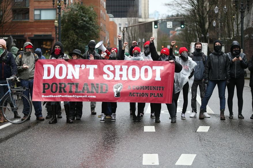 People participate in a protest Monday, Feb. 20, 2017, in Portland, Ore. Thousands of demonstrators turned out Monday across the U.S. to challenge President Donald Trump in a Presidents Day protest dubbed Not My President's Day. (Dave Killen/The Oregonian via AP)