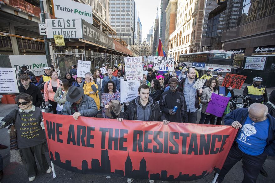 People march during a protest Monday, Feb. 20, 2017, in Philadelphia. Thousands of demonstrators turned out Monday across the U.S. to challenge Donald Trump in a Presidents Day protest dubbed Not My President's Day. (Michael Bryant/The Philadelphia Inquirer via AP)