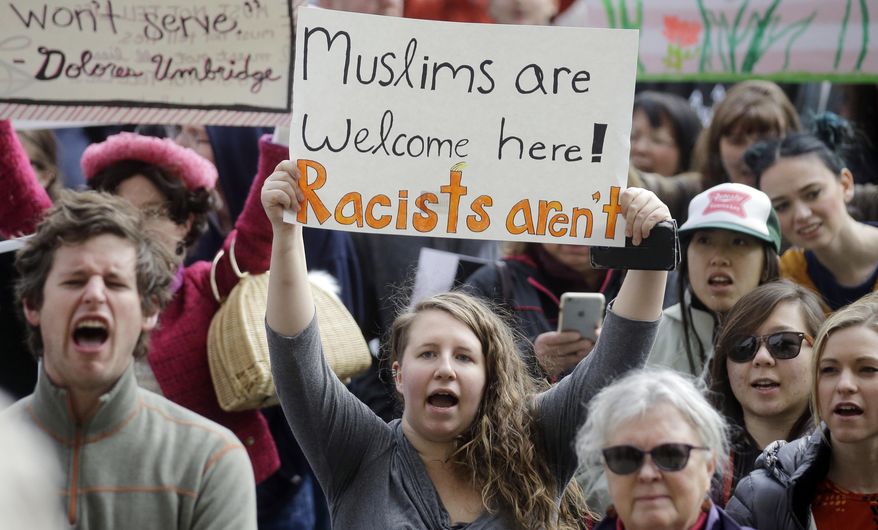 Demonstrators hold a rally Monday, Feb. 20, 2017, in Salt Lake City. The rally is one of several Not My Presidents Day protests planned across the country to mark the Presidents Day holiday. Protesters are criticizing President Donald Trump's immigration policies, among other things. (AP Photo/Rick Bowmer)