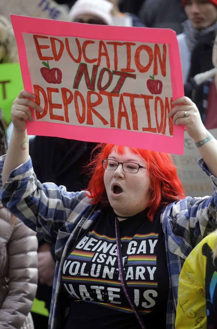 Demonstrators hold a rally Monday, Feb. 20, 2017, in Salt Lake City. The rally is one of several Not My Presidents Day protests planned across the country to mark the Presidents Day holiday. Protesters are criticizing President Donald Trump's immigration policies, among other things. (AP Photo/Rick Bowmer)