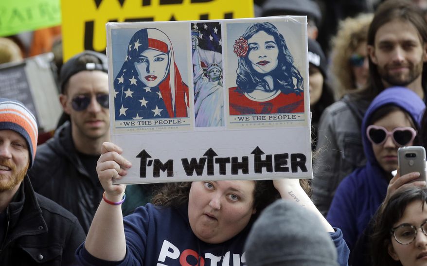 Demonstrators hold a rally Monday, Feb. 20, 2017, in Salt Lake City. The rally is one of several Not My Presidents Day protests planned across the country to mark the Presidents Day holiday. Protesters are criticizing President Donald Trump's immigration policies, among other things. (AP Photo/Rick Bowmer)