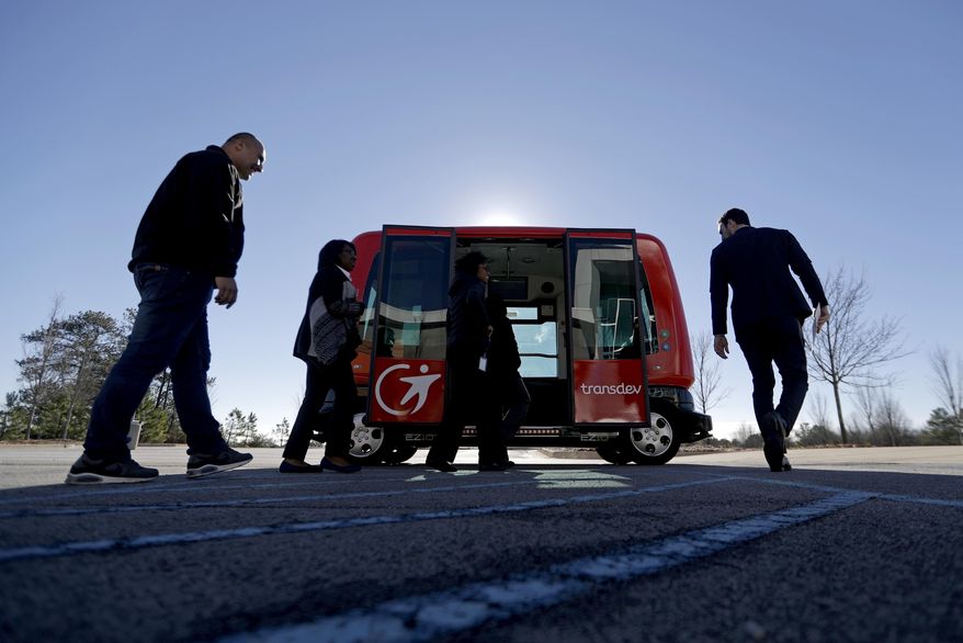 In this Thursday, Jan. 26, 2017 photo, a driverless shuttle sits on display at the Riverside EpiCenter in Austell, Ga. Self-driving vehicles could begin tooling down a bustling Atlanta street full of cars, buses, bicyclists and college students, as the city vies with other communities nationwide to test the emerging technology. (AP Photo/David Goldman)