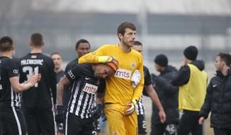 Partizan Belgrade&#39;s Brazilian player Everton Luiz, centre left, leaves the field accompanying by goalkeeper Filip Kljajic, during a Serbian championship match between Rad and Partizan, in Belgrade, Serbia, Sunday, Feb. 19, 2017. Luiz was in tears after suffering persistent racist chants during his team&#39;s 1-0 victory against Rad in the Serbian premiership. The Brazilian, who joined Partizan from the Swiss league in 2016, received monkey chants and other abuse, including a racist banner on the stands where Rad fans were standing. (AP Photo/Miroslav Todorovic)