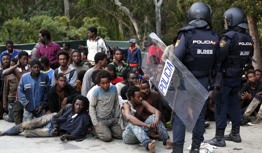 Migrants were captured by Spanish police after storming a fence to enter the Spanish enclave of Ceuta. Relentless waves of people have made the trek to the Spanish border seeking to escape the desperate poverty, terrorist violence, criminal bureaucracy and chaos of their respective countries in sub-Saharan and North Africa. (Associated Press/File) 