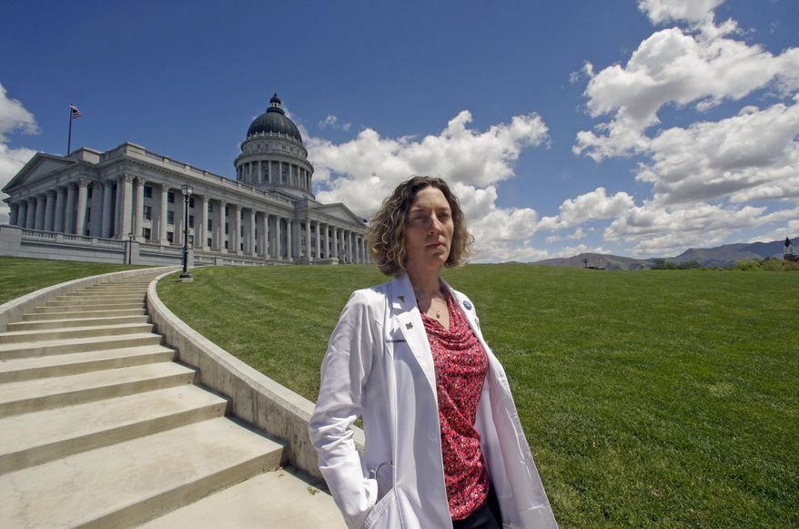 FILE - In this May 10, 2016, file photo, Dr. Leah Torres, an obstetrician-gynecologist, poses for a photo at the Utah State in Salt Lake City. Last year, Utah enacted a first-in-the-nation law requiring that fetuses receive anesthesia or painkillers before elective abortions starting at 20 weeks gestation. Nine months later, the only licensed clinic providing those abortions in the state says no changes have been made in how doctors perform the procedures. Dr. Torres, one of five or six licensed physicians who perform elective late-term abortions at the clinic, said she went to legislators, the governor's office and the attorney general's office seeking an explanation on what treatment she's supposed to give. She said they gave her none and recommended she speak to a lawyer. (AP Photo/Rick Bowmer, File)
