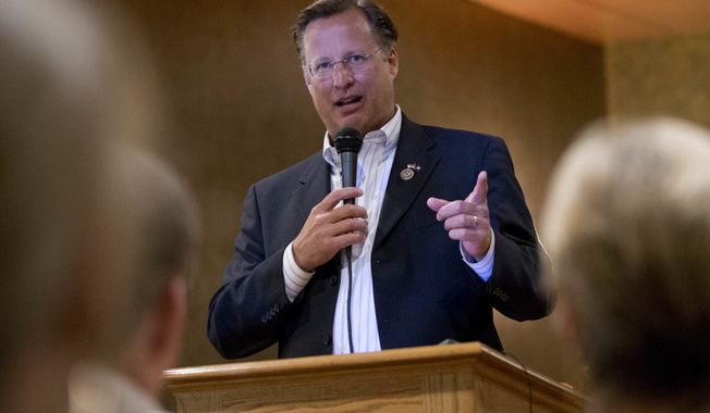 Congressman Dave Brat, R-Va., answers a question during a town hall meeting with the congressman in Blackstone, Va., Tuesday, Feb. 21, 2017. (AP Photo/Steve Helber)