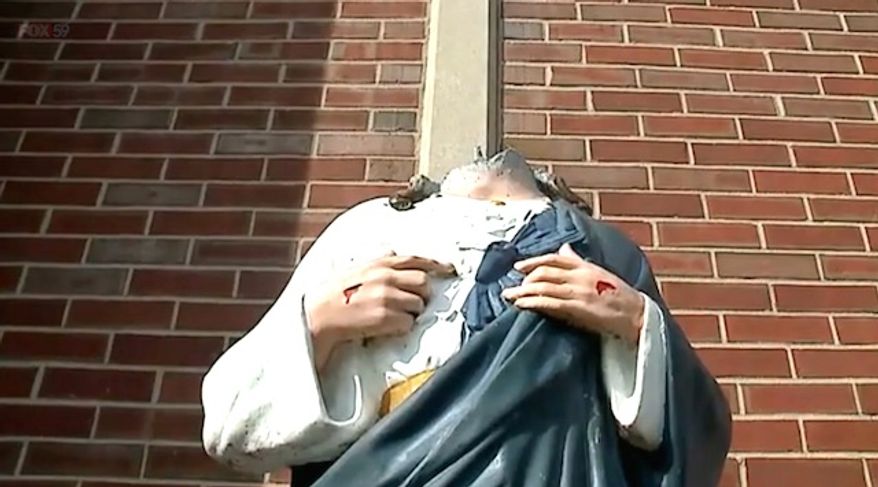 A statue outside the Cottage Avenue Pentecostal Fellowship in Indianapolis, Indiana, was the target of vandalism twice in two weeks. Its status of Jesus has been beheaded multiple times. (Fox 59 Indiana screenshot)