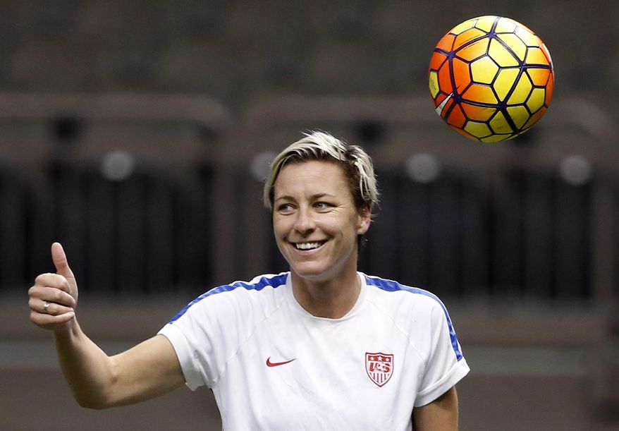 FILE - In this Dec. 15, 2015, file photo, U.S. forward Abby Wambach reacts during a practice session in New Orleans for Wednesday's final U.S. victory tour match, against China. Wambach and Christian writer Glennon Doyle Melton announced their engagement on Feb. 18, 2017. (AP Photo/Gerald Herbert, File)