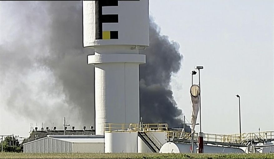 In this image made from video, smoke billows from the site of a plane crash at Essendon Airport in Melbourne, Australia Tuesday, Feb. 21, 2017. An official says a light plane has crashed into a shopping mall in the city of Melbourne. The mall adjoins the airport. (Channel 9 via AP)