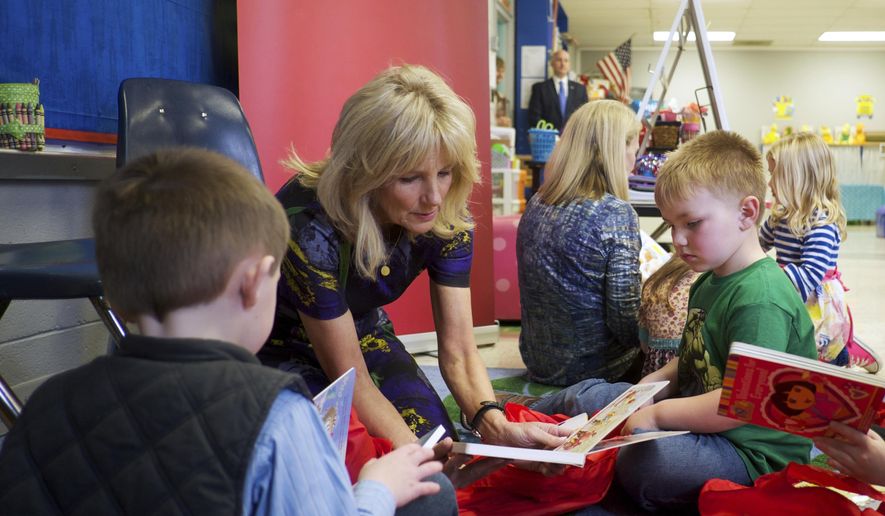 In this Feb. 15, 2017 photo provided by Save the Children, Dr. Jill Biden speaks with students Gus Mathis, right, and Cole Swindle, during Biden&#x27;s visit with Save the Children at Linden Elementary School in Linden, Tenn. Biden, educator and wife of former Vice President Joe Biden, was named board chair of Save the Children, which focuses on the health, education and safety of kids, announced Tuesday, Feb. 21, 2017. (Shawn Millsaps/Save the Children via AP)