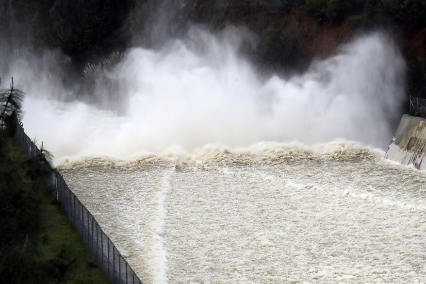 Water from the Lake Anderson Reservoir gushes down a spillway Tuesday, Feb. 21, 2017, in Morgan Hill, Calif. Rains have saturated once-drought stricken California but have created chaos for residents hit hard by the storms. The latest downpours swelled waterways to flood levels and left about half the state under flood, wind and snow advisories. (AP Photo/Marcio Jose Sanchez)
