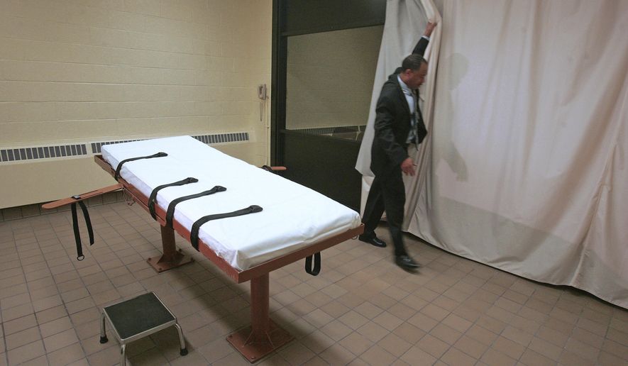 FILE – In this November 2005 file photo, Larry Greene, public information director of the Southern Ohio Correctional Facility, demonstrates how a curtain is pulled between the death chamber and witness room at the prison in Lucasville, Ohio. Legal arguments over the constitutionality of Ohio's lethal injection process, and specifically the effectiveness of the sedative midazolam, are set to be heard by the 6th U.S. Circuit Court of Appeals on Tuesday, Feb. 21, 2017, in Cincinnati, months before the state hopes to start carrying out executions again. (AP Photo/Kiichiro Sato, File)
