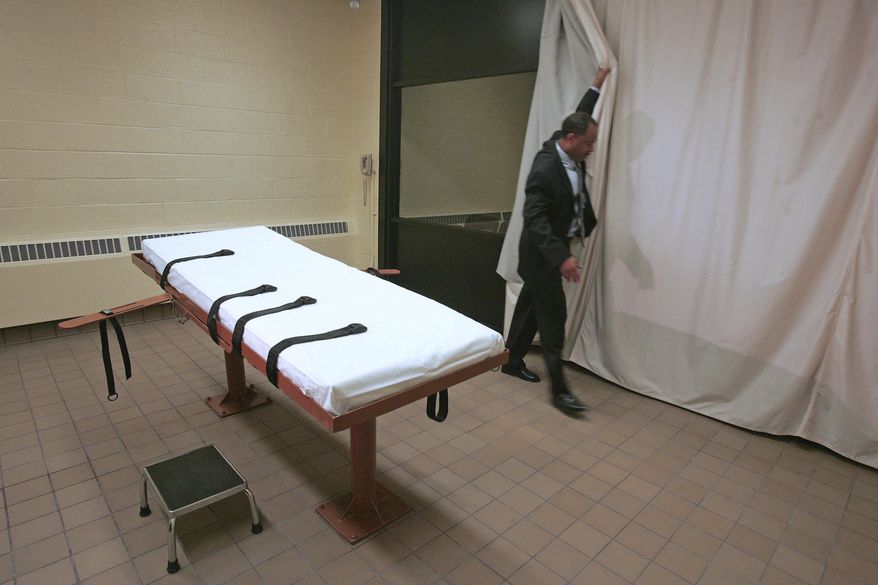 FILE – In this November 2005 file photo, Larry Greene, public information director of the Southern Ohio Correctional Facility, demonstrates how a curtain is pulled between the death chamber and witness room at the prison in Lucasville, Ohio. Legal arguments over the constitutionality of Ohio's lethal injection process, and specifically the effectiveness of the sedative midazolam, are set to be heard by the 6th U.S. Circuit Court of Appeals on Tuesday, Feb. 21, 2017, in Cincinnati, months before the state hopes to start carrying out executions again. (AP Photo/Kiichiro Sato, File)
