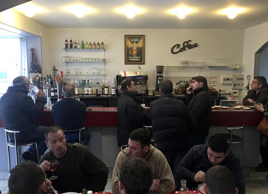 Client enjoy a meal or a drink at the local cafe "Le Bouche à Oreille" restaurant Monday, Feb. 20, 2017 in Bourges, central France. The Michelin Guide has accidentally awarded one of its coveted stars to the cafe that shares its name with a gastronomic restaurant 150 kilometers (93 miles) away. (AP Photo/Milos Krivokapic)