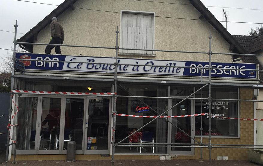 A man stands on the scaffolding of the local cafe "Le Bouche à Oreille" restaurant Monday, Feb. 20, 2017 in Bourges, central France. The Michelin Guide has accidentally awarded one of its coveted stars to the cafe that shares its name with a gastronomic restaurant 150 kilometers (93 miles) away. (AP Photo/Milos Krivokapic)
