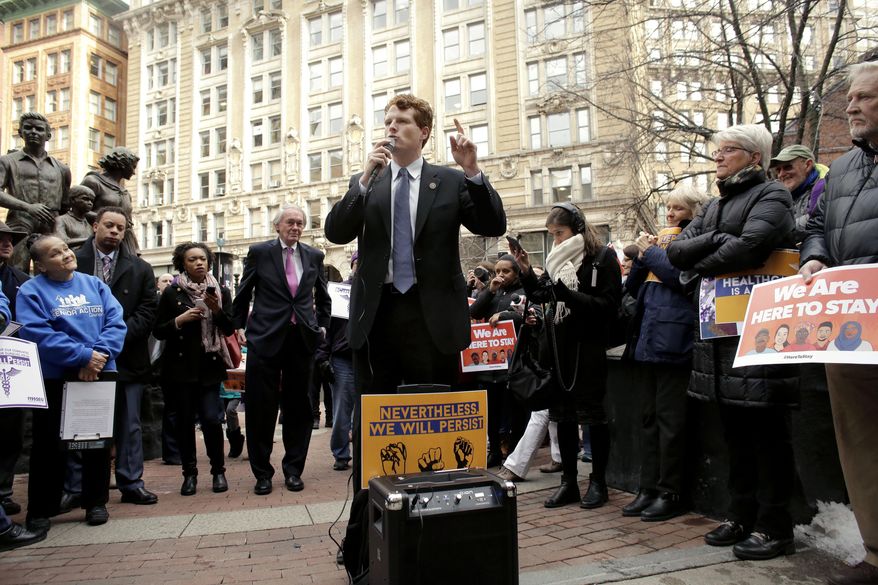 Rep. Joseph P. Kennedy III, D-Mass., center front, addresses a crowd as Sen. Ed Markey, D-Mass., center left, as they join workers, immigrants, and community advocates during a rally called "We Will Persist," Tuesday, Feb. 21, 2017, in Boston. According to organizers the rally was held to send a message to Republicans in Congress and the administration of President Donald Trump that they will continue to press for immigration rights and continued affordable healthcare coverage. (AP Photo/Steven Senne)