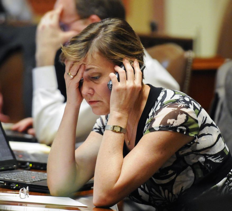 FILE - In this May 15, 2010, file photo, Minnesota state Rep. Kim Norton DFL-Rochester, works in the final hours of the session at the State Capitol in St Paul. Legislators in Minnesota haven't given themselves a pay raise in nearly 20 years. Norton, a Minnesota Democrat, said she decided not to seek another term in the state House, and the $31,000 salary was a factor. (AP Photo/Craig Lassig, File)