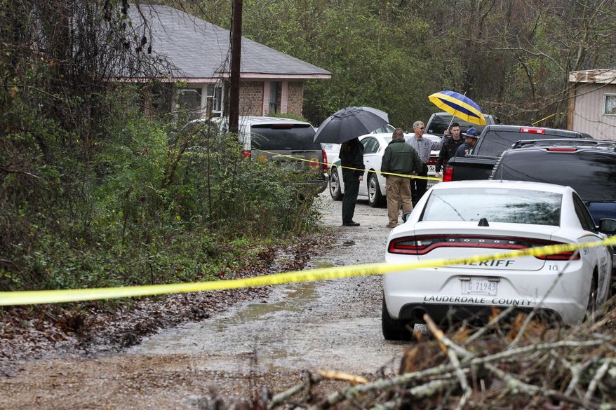 Lauderdale County authorities investigate the shooting deaths of four members of a family in Toomsuba, Miss., Tuesday, Feb. 21, 2017. (Paula Merritt /The Meridian Star via AP)