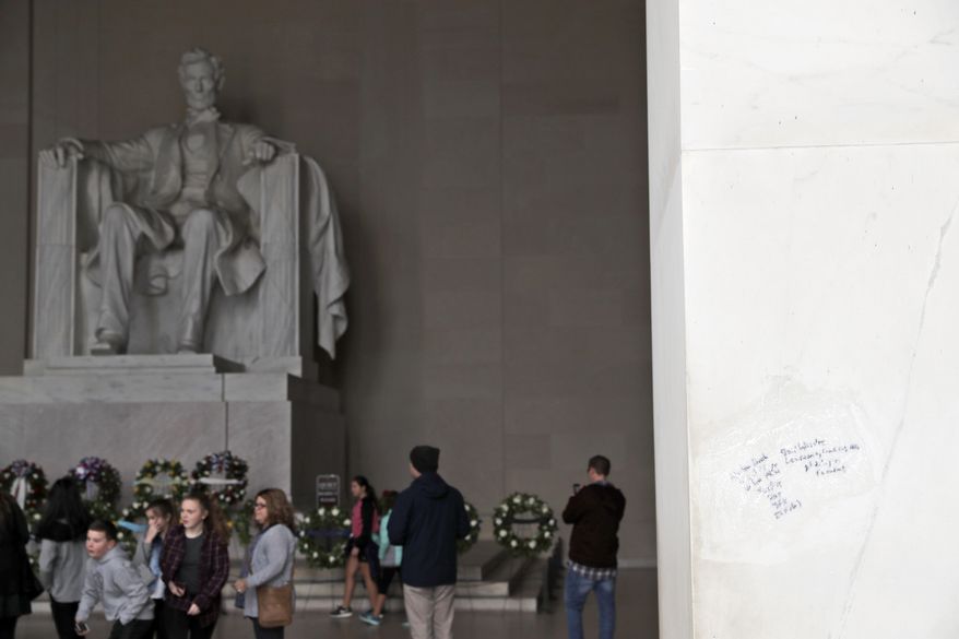Graffiti is seen on the Lincoln Memorial, Tuesday, Feb. 21, 2017, in Washington. U.S. Park Police spokeswoman Sgt. Anna Rose said that the messages written in permanent marker were discovered over the holiday weekend at the Lincoln Memorial, the Washington Monument and the World War II Memorial. (AP Photo/Alex Brandon)