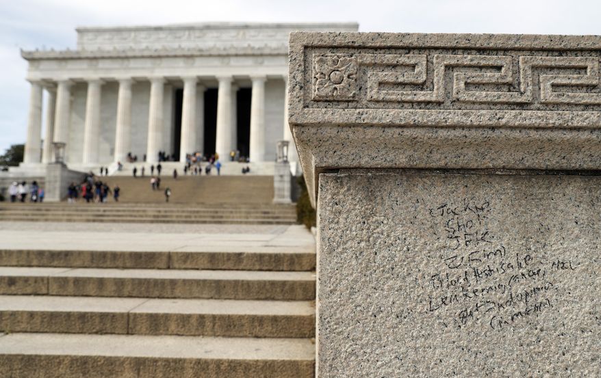 Graffiti is seen near the steps of the Lincoln Memorial, Tuesday, Feb. 21, 2017, in Washington. U.S. Park Police spokeswoman Sgt. Anna Rose said that the messages written in permanent marker were discovered over the holiday weekend at the Lincoln Memorial, the Washington Monument and the World War II Memorial. (AP Photo/Alex Brandon)