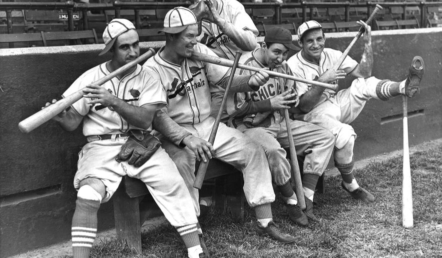 FILE - In this Sept. 30, 1938 file photo, Rip Collins, Chicago first baseman and former Cardinal, joined his old teammates in a burlesque of John Pepper Martin's mudcat band in St. Louis, from left, Stan Bordagaray, Bill McGee, Collins, and Pepper himself are dancing out a on their bats, while Bob Weiland (standing, rear) finds his glove sufficient. The Abraham Lincoln Presidential Museum plans to unveil an exhibit chronicling the history of the rivalry between the Chicago Cubs and the St. Louis Cardinals opens March 24, 2017 in Springfield, Ill. (AP Photo File)
