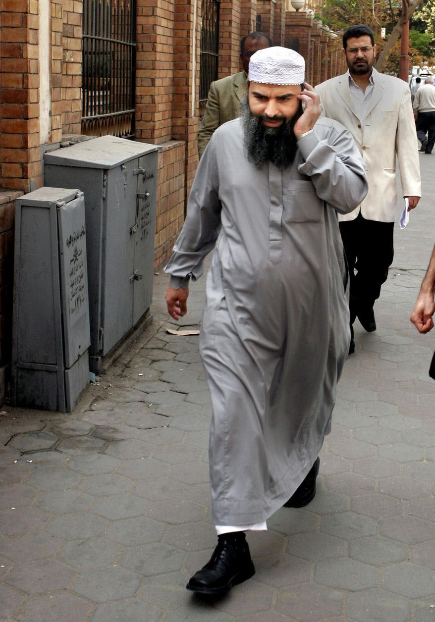 FILE -- In this file photo taken on April 11, 2007, Egyptian cleric Osama Hassan Mustafa Nasr, known as Abu Omar, who was allegedly kidnapped by CIA agents off the streets of an Italian city and taken to Egypt where he said he was tortured, talks on his mobile as he walks at a Cairo street after attending Amnesty International press conference in Cairo, Egypt.  A Portuguese court ordered police to extradite a former CIA agent Sabrina de Sousa to Italy, where she is due to serve a four-year prison sentence after being convicted of involvement in a U.S. program that kidnapped suspects for interrogation, her lawyer said Tuesday, Feb. 22, 2017. De Sousa was among 26 Americans convicted for kidnapping suspect Mustafa Nasr.  (AP Photo/Amr Nabil, File)