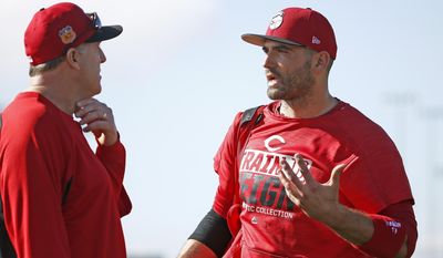 Cincinnati Reds first baseman Joey Votto, right, talks with manager Bryan Price, left, at the team&#x27;s baseball spring training facility Monday, Feb. 20, 2017, in Goodyear, Ariz. (AP Photo/Ross D. Franklin)